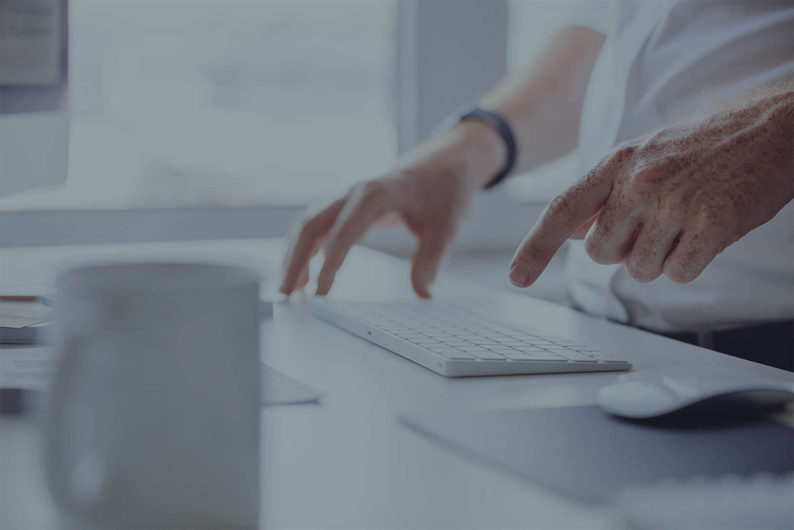 man typing on computer keyboard